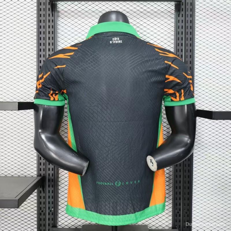 Player Version 2025 Ivory Coast Black with Elephant Graphic and Orange Stripes Jersey